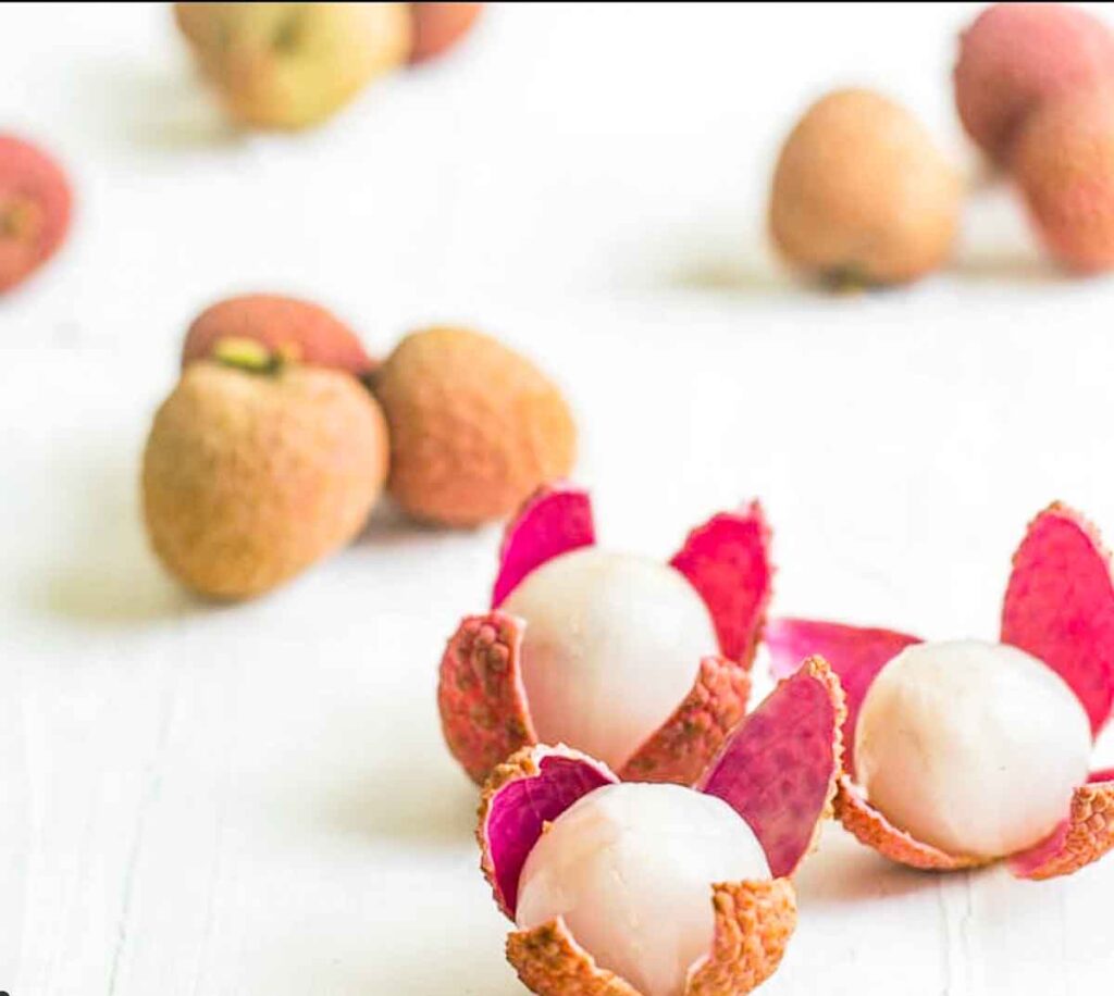 a few juicy lychee or litchi on a surface