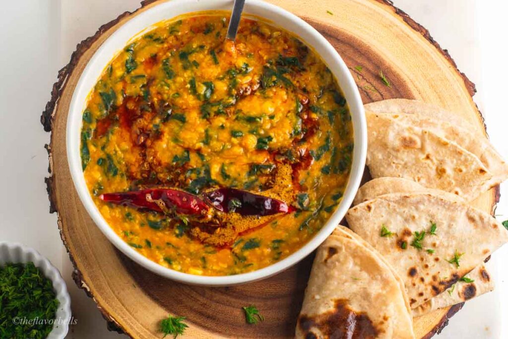 overhread shot of daal palak tempered with red chilli