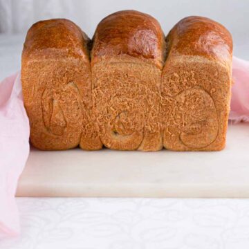 loaf of a dairy free bread placed on a marble board