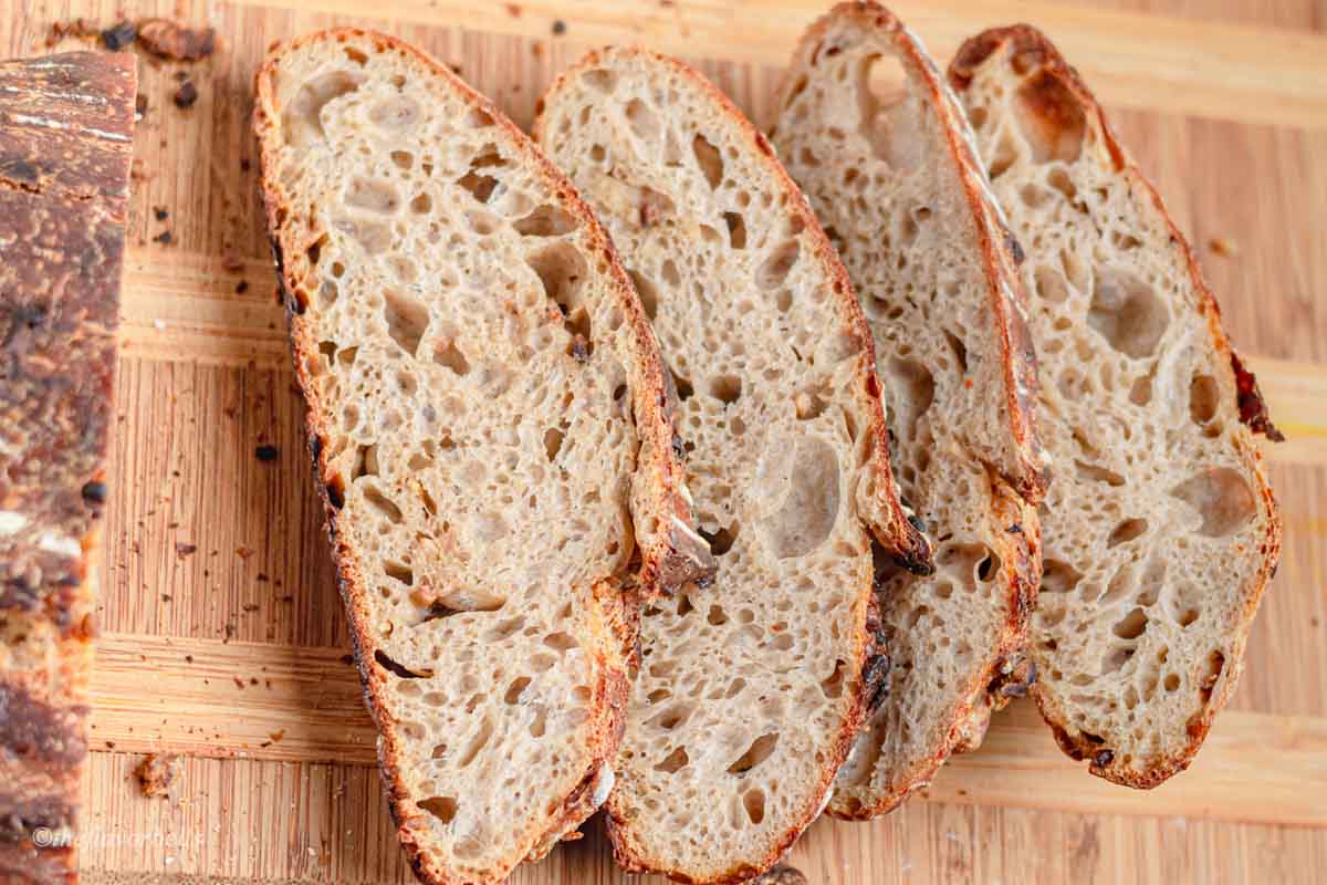 open and chewy garlic sourdough crumb shown in 4 slices