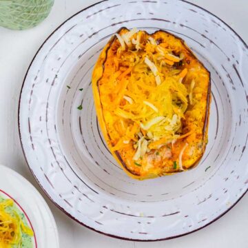 air fried spaghetti squash stuffed with cheese and herbs and served on a plate