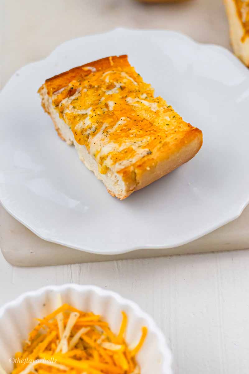 a pice of cheese garlic bread on a plate