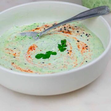 stirring the thick cilantro garlic sauce with a spoon
