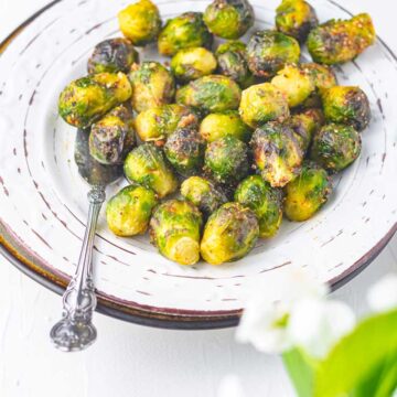air fried frozen brussel sprouts in a plat with serving spoon
