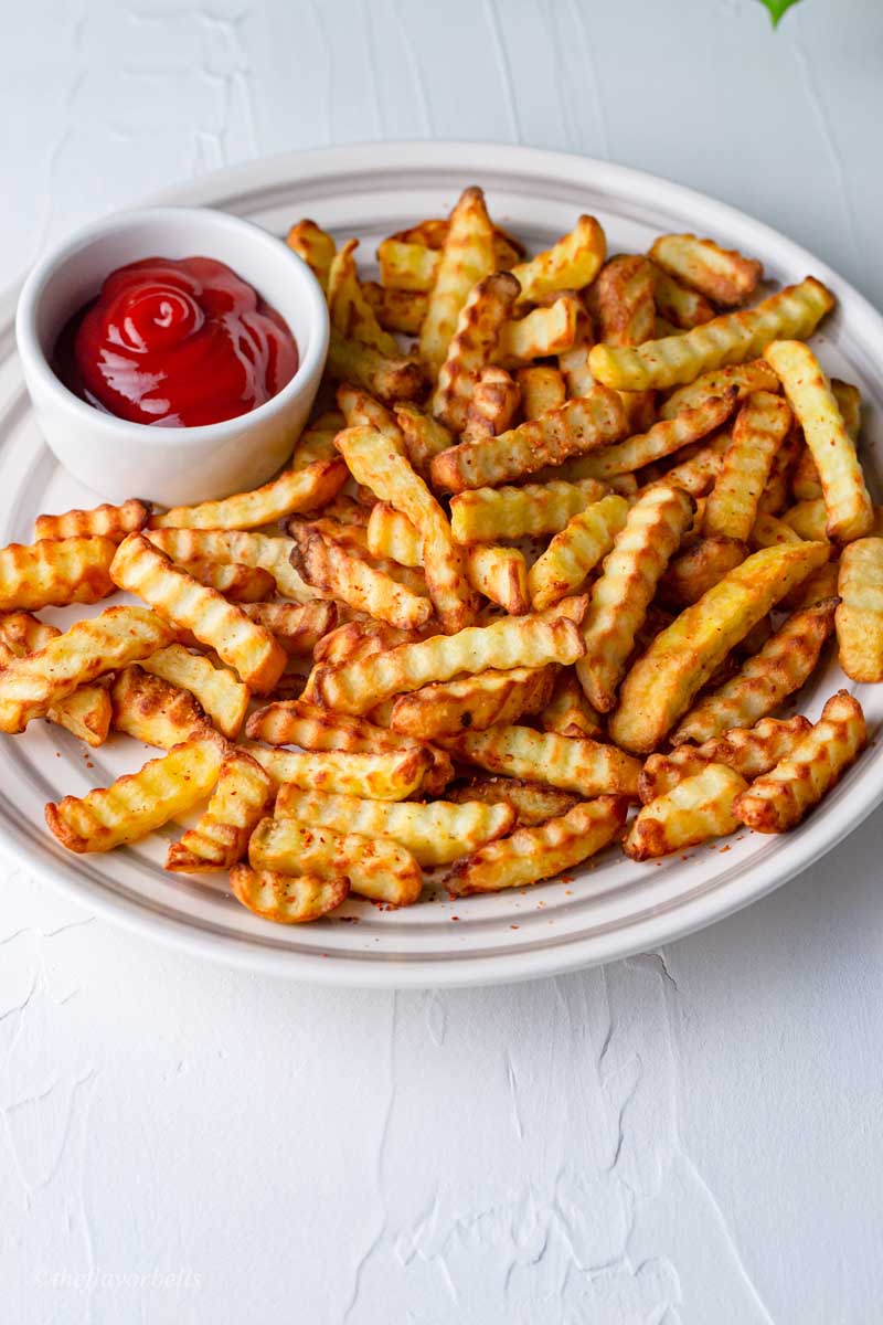 frozen crinkle cut fries made in air fryer and served with sauce.
