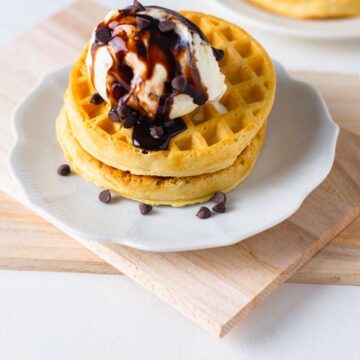 frozen waffles made in air fryer and served with scoop of ice cream and chocolate syrup with chocolate chips