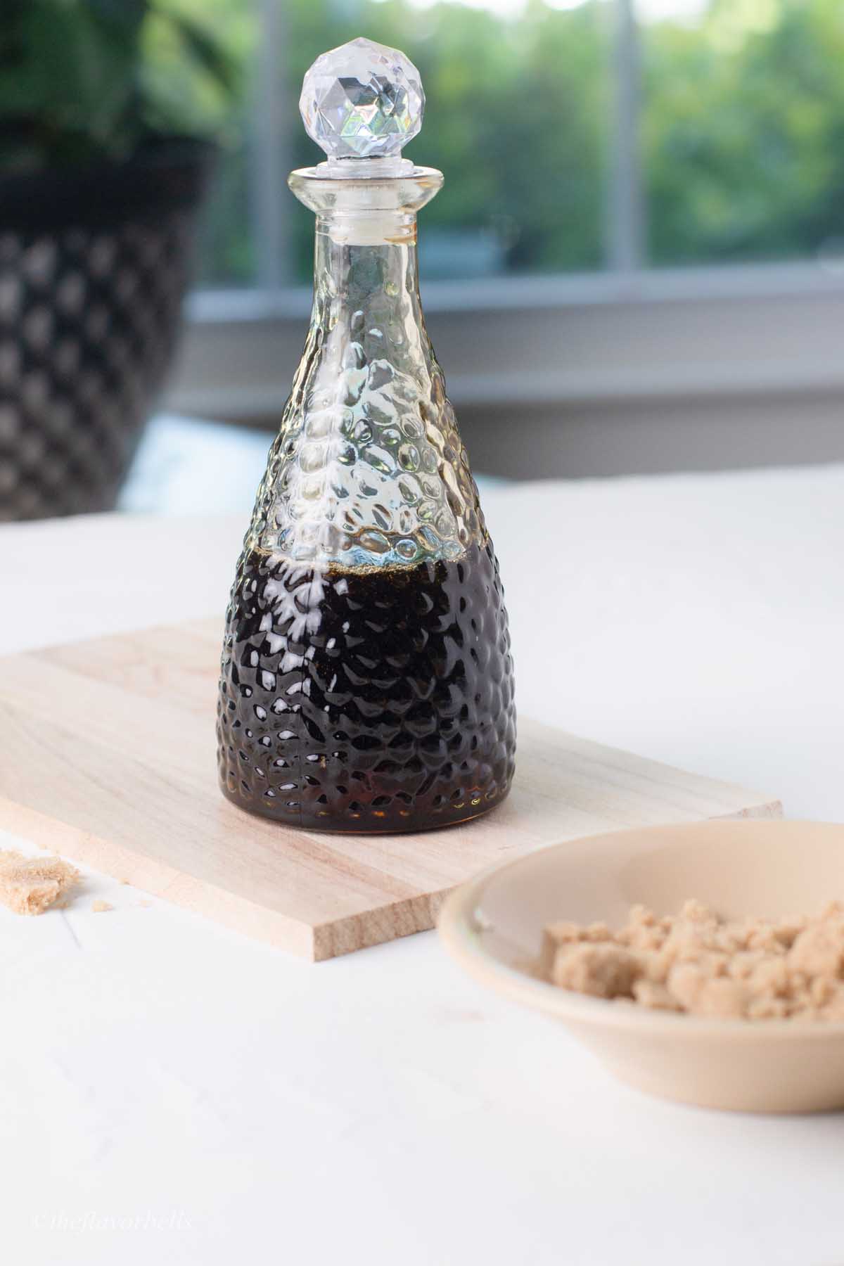 homemade thick brown sugar syrup in a glass bottle.
