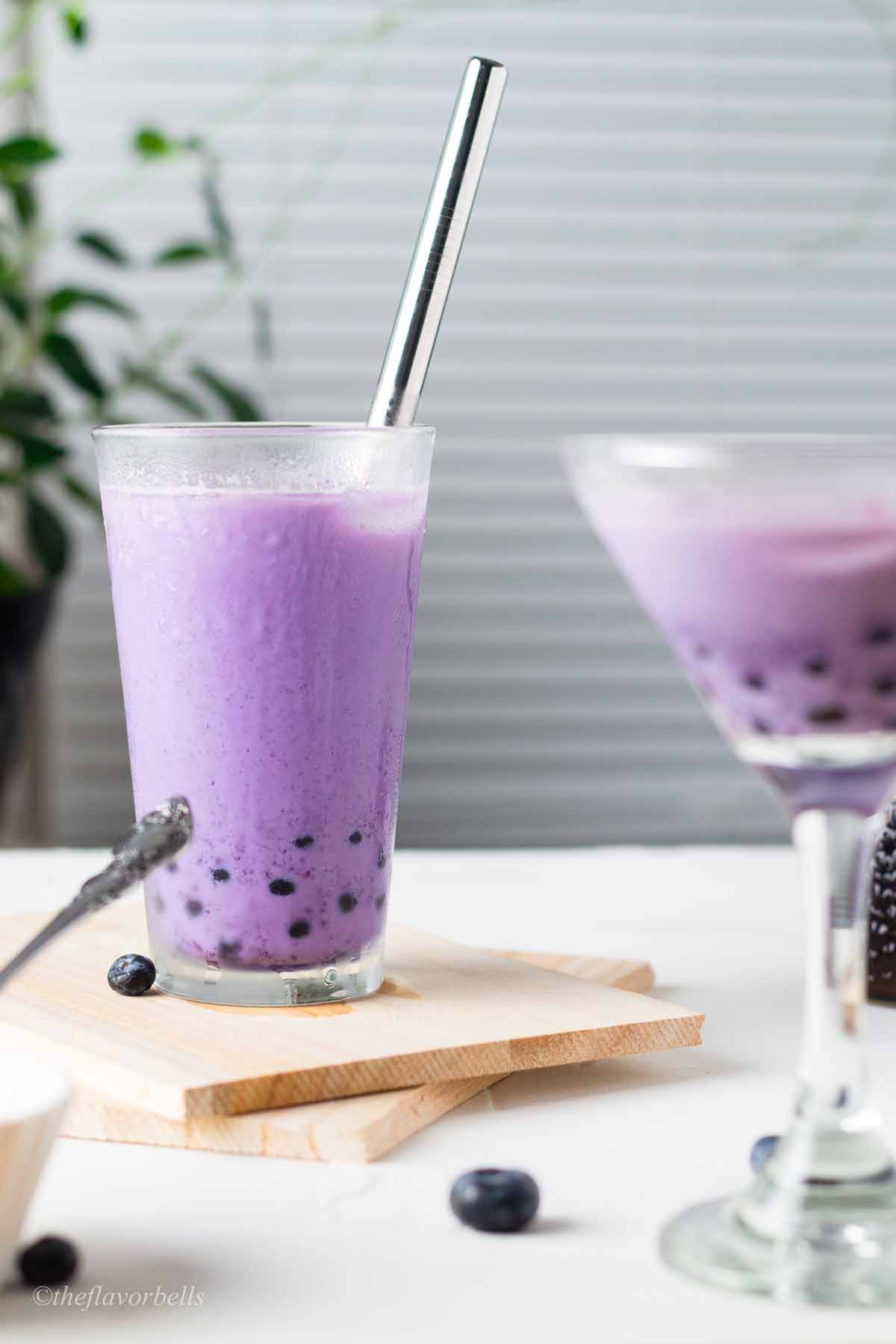 two glasses filled with blueberry milk tea