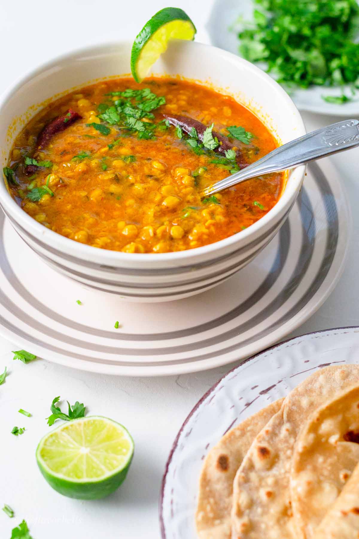 chana dal in bowl with roti in a plate