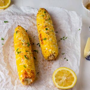 Air fryer frozen corn on the cob slathered with butter