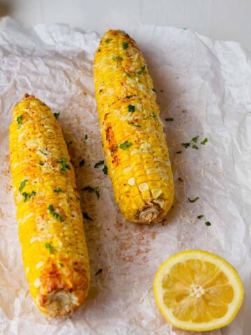 Air fryer frozen corn on the cob slathered with butter