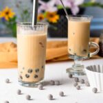 two glasses of caramel milk tea served with black boba pearls