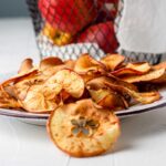 the apple slices that are dehydrated in air fryer in a plate
