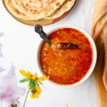 toor dal made in instant pot in a bowl served alongside indian flatbread