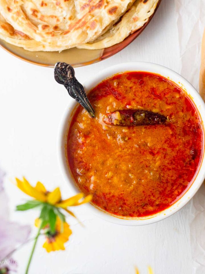 toor dal made in instant pot in a bowl served alongside indian flatbread