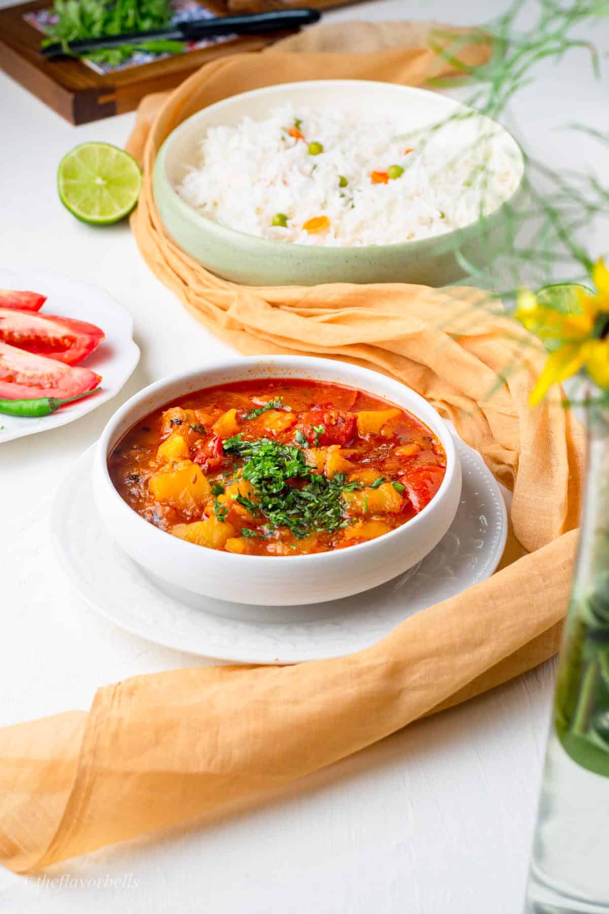 tomato and potato curry looking glorious and served with rice