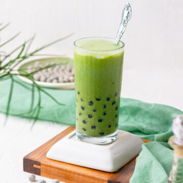 a glass of matcha bubble tea