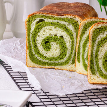 matcha bread being sliced into a few slices to show the matcha swirls