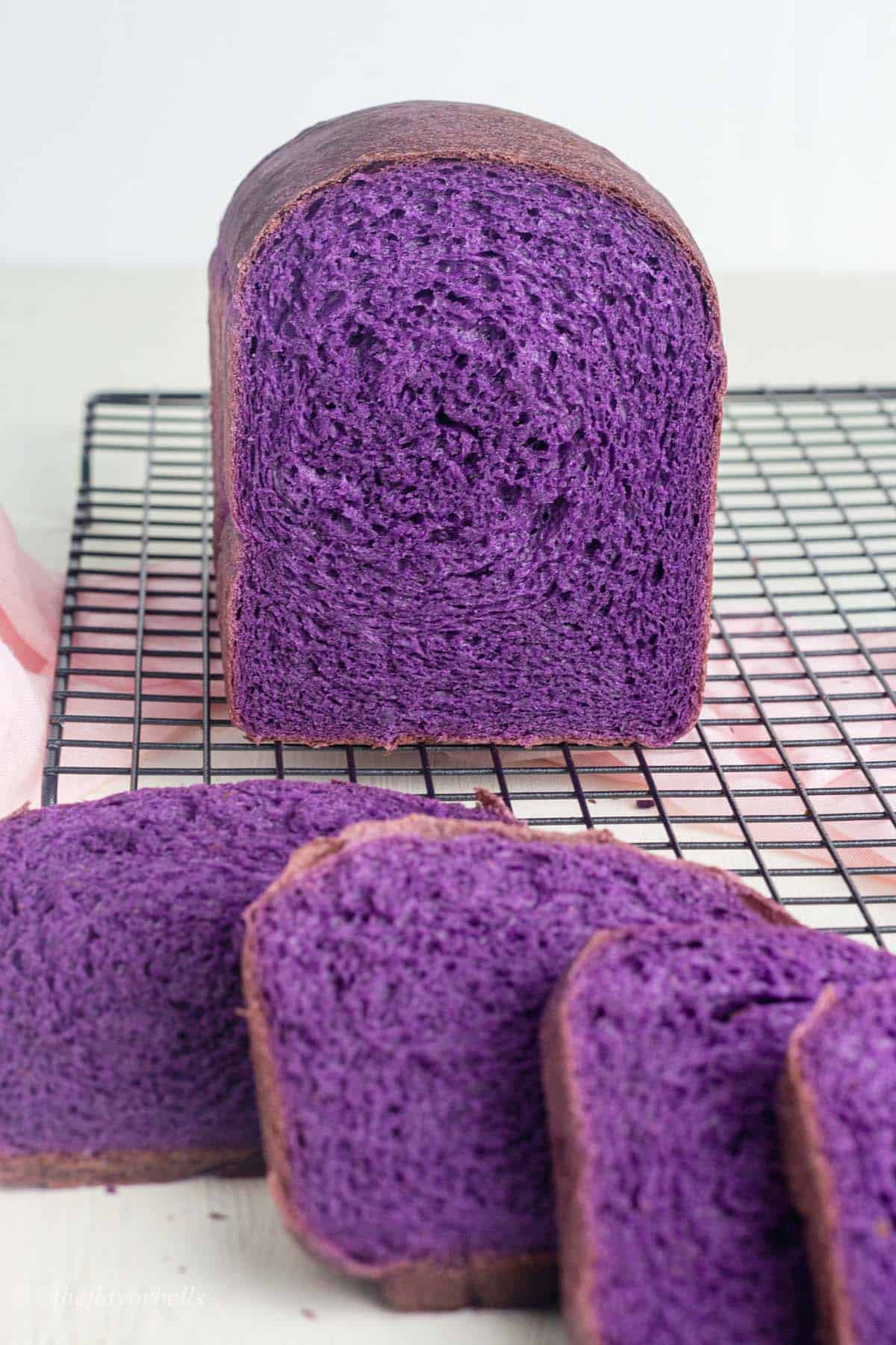 purple yam bread on a wire cooling rack