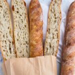 slices and full sourdough baguettes with soft and open crumb