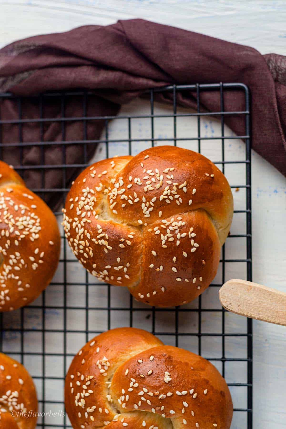 close-up shot of a challah roll topped with sesame seeds