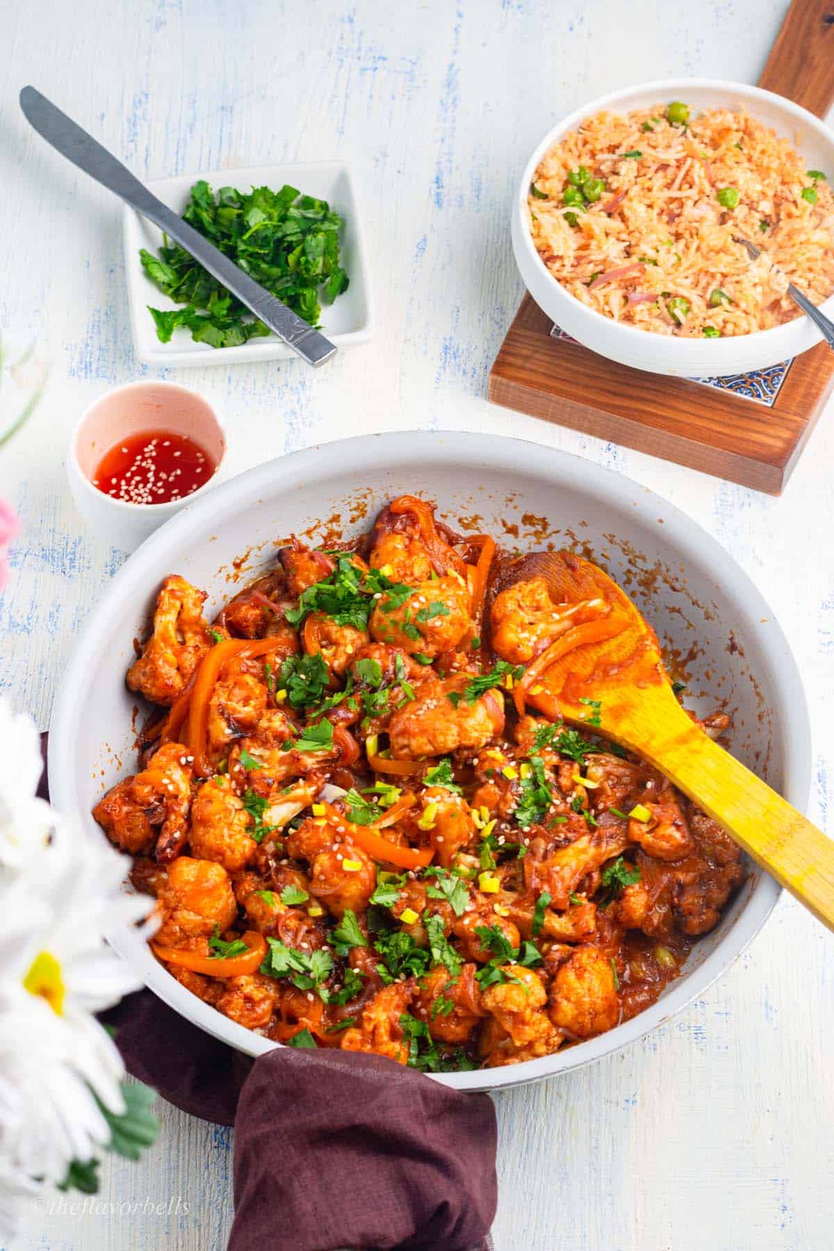 gobi manchurian in a pan and fried rice in a bowl
