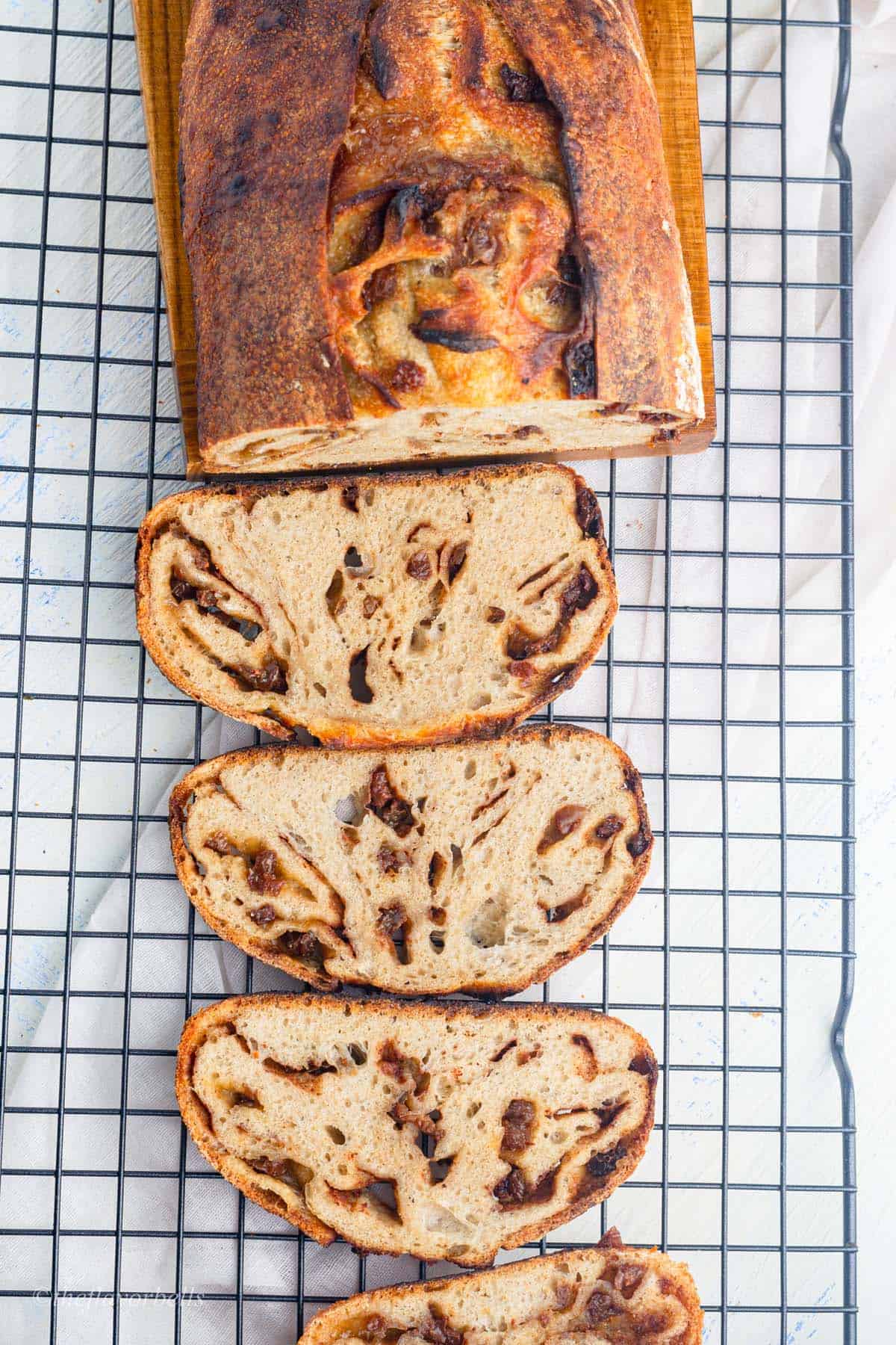 cinnamon swirl sourdough bread slices on a wire cooling rack