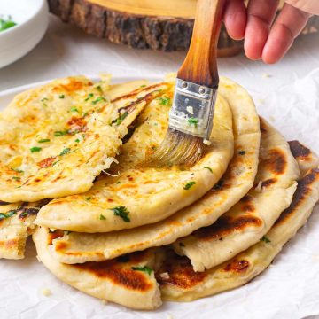 image showing brushing the naan with garlic butter
