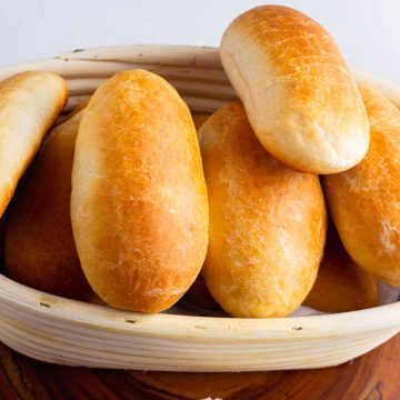 Close-up of bite-sized hot dog buns in a blanket with a crispy, golden crust, perfect for snacking.