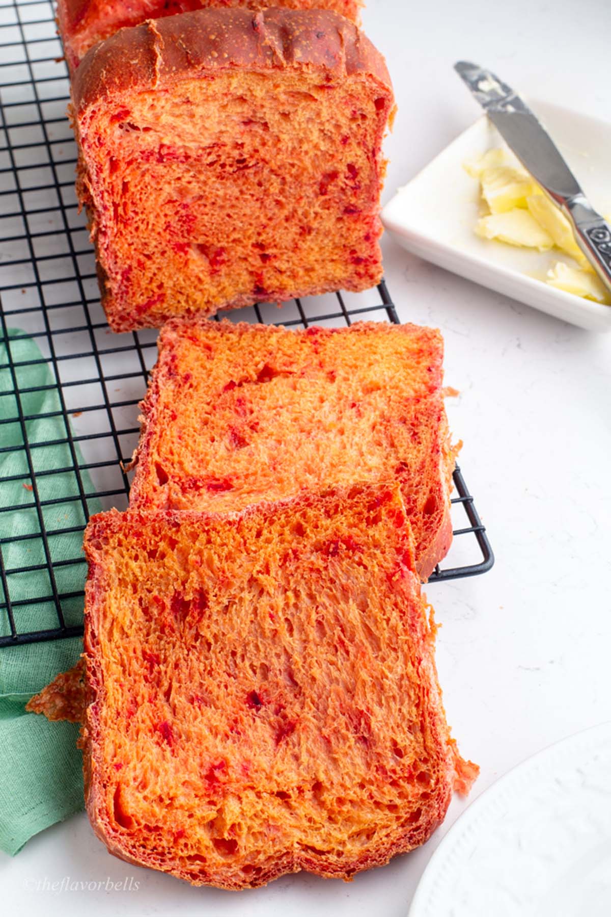 two slices of bread made with beet root juice grated pieces of beet root