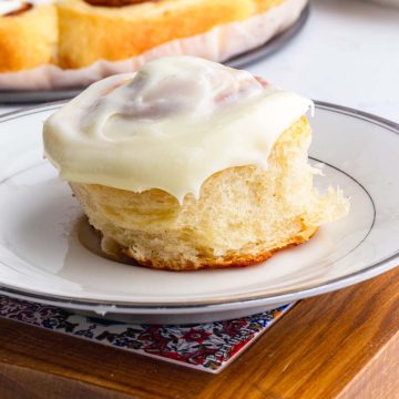 brioche cinnamon rolls placed in a serving plate showcasing its tender and buttery crumbs