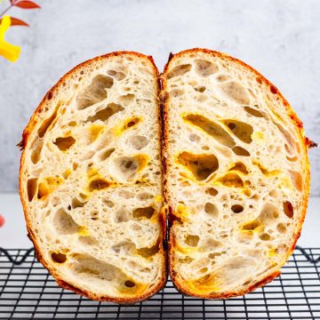 a sliced loaf showing open crumbs of sourdough bread
