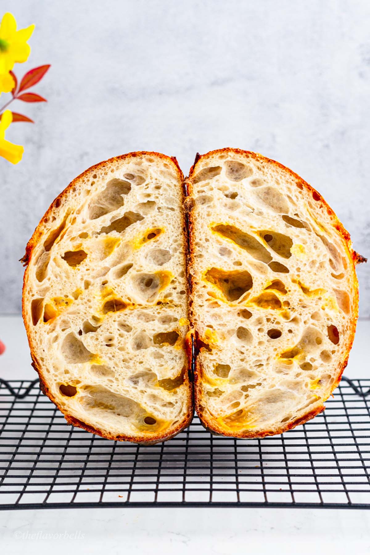 a sliced loaf showing open crumbs of sourdough bread