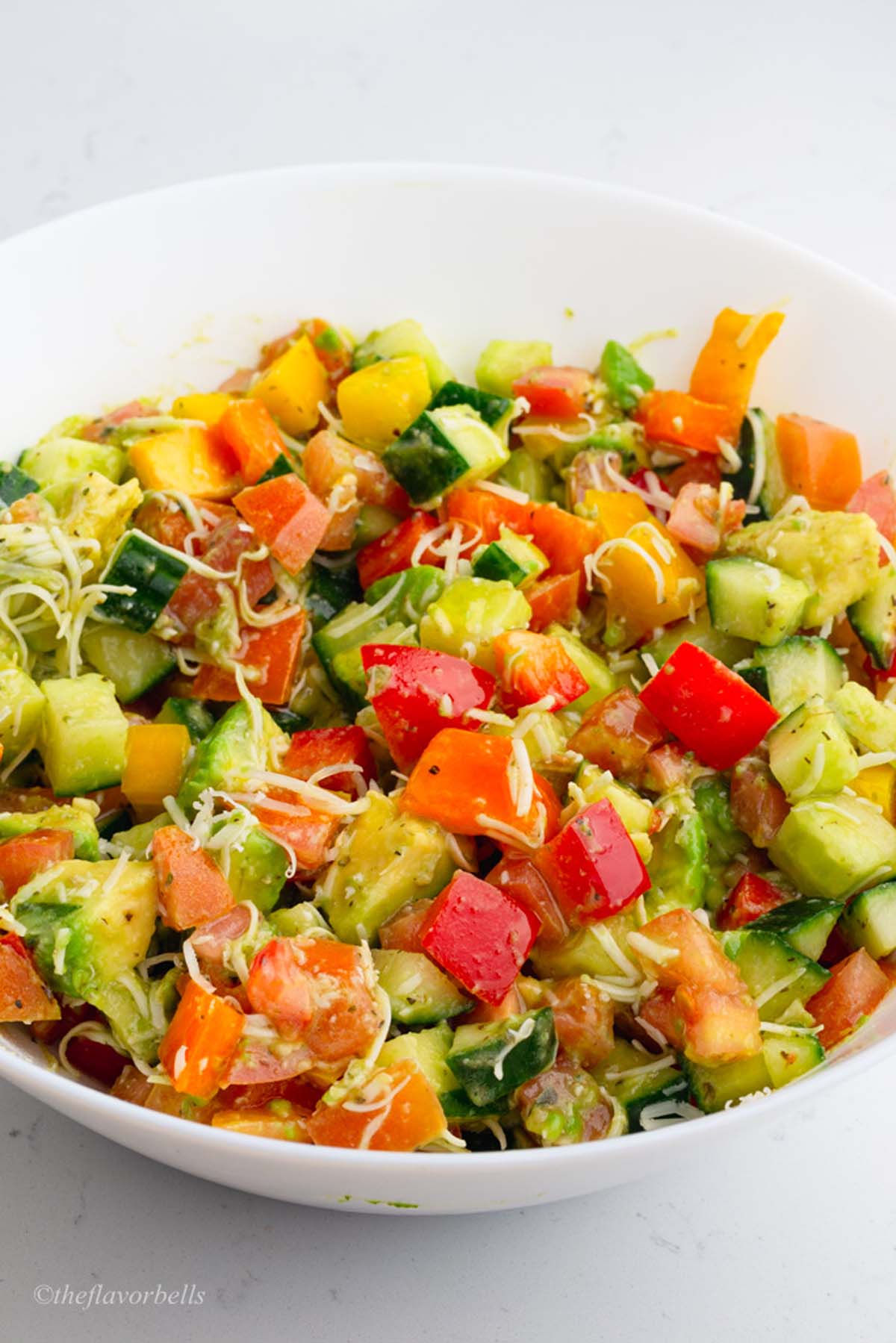 vegetarian salad made with cucumber, peppers, and avocado served in a bowl