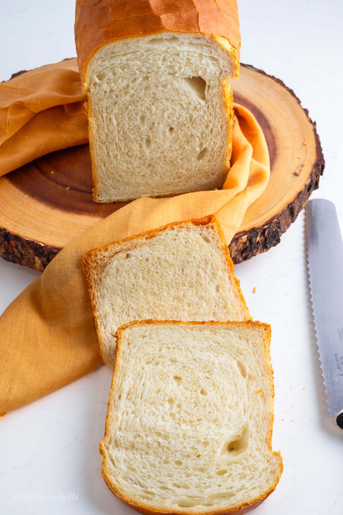 Detailed close-up of the soft crumbs in a sliced sourdough discard sandwich bread loaf, showcasing the first few slices freshly cut