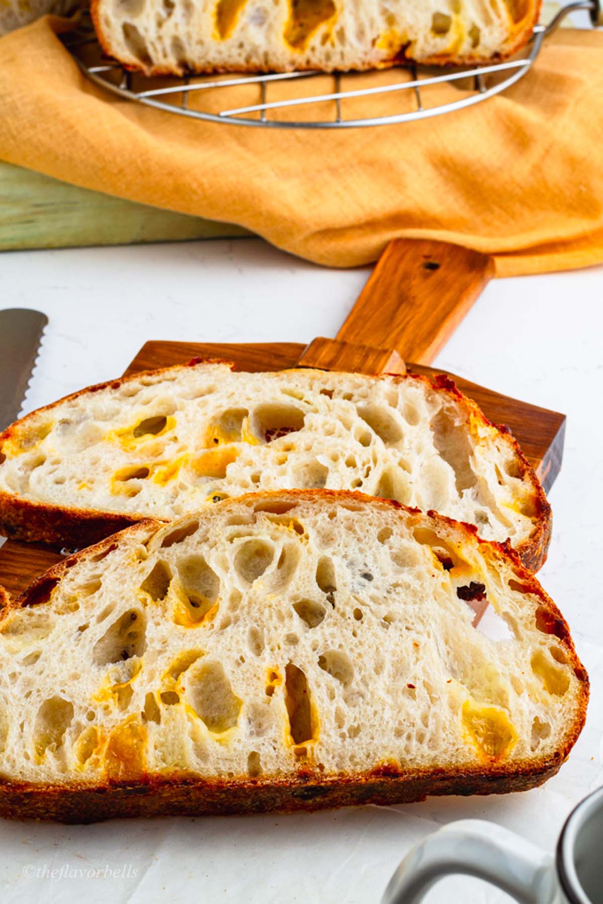 slices of cheese filled sourdough resting on a plating board