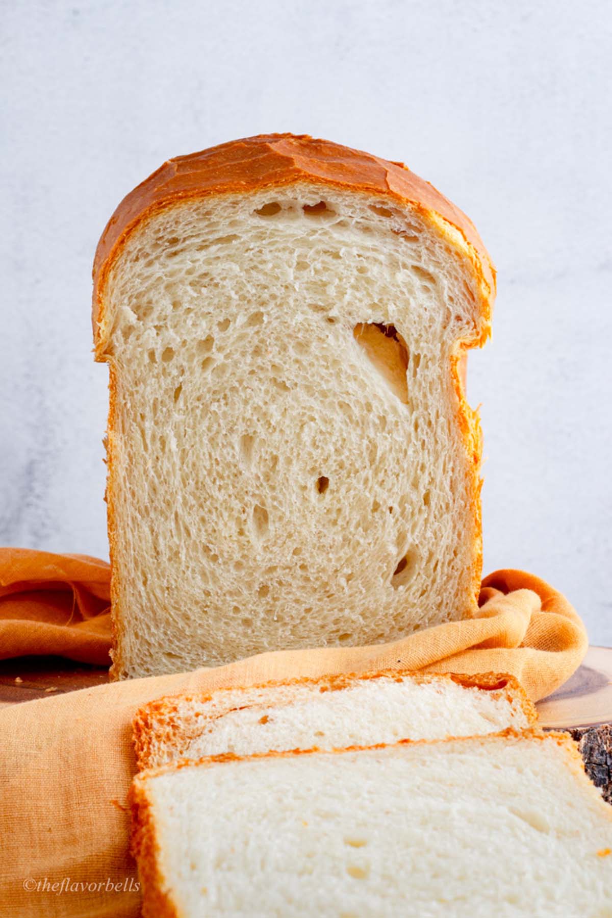 a close up look at the super soft and tender crumbs of a loaf made using sourdough discard