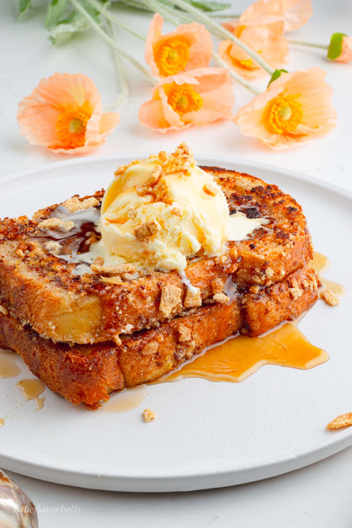 2 slices of Cinnamon crunch french toast served on a white plate.