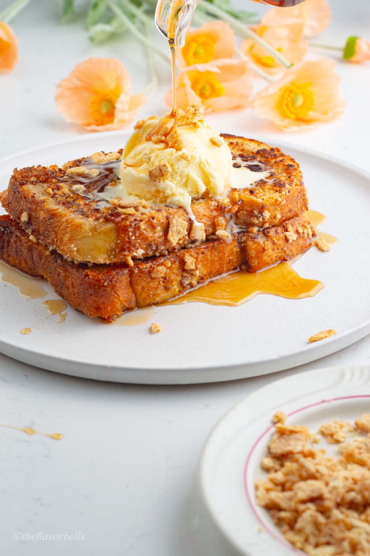 image showing drizzling of maple syrup on the cinnamon crunch french toast