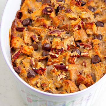 a casserole of sourdough pudding topped with chopped pecan and chocolate chips with caramelized custard on the edges. So good!