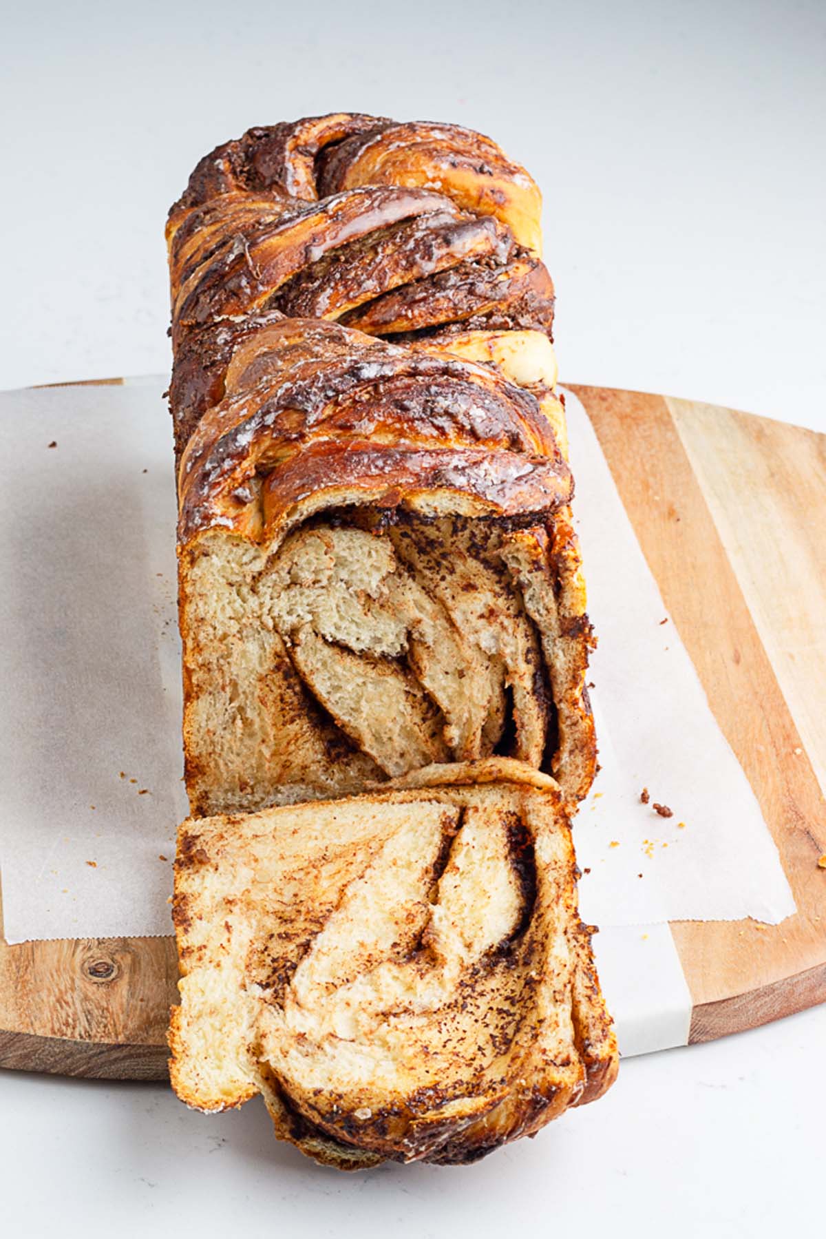 a loaf of Nutella babka sliced to show the swirls of Nutella