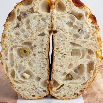 loaf of feta and olive sourdough sliced into halves