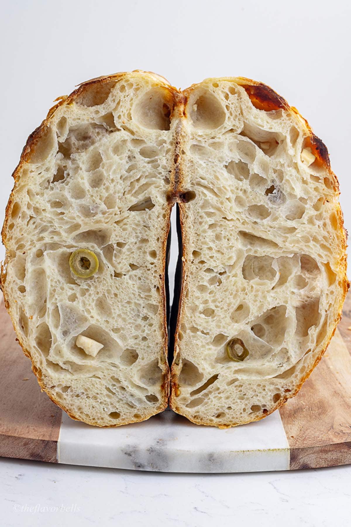loaf of feta and olive sourdough sliced into halves