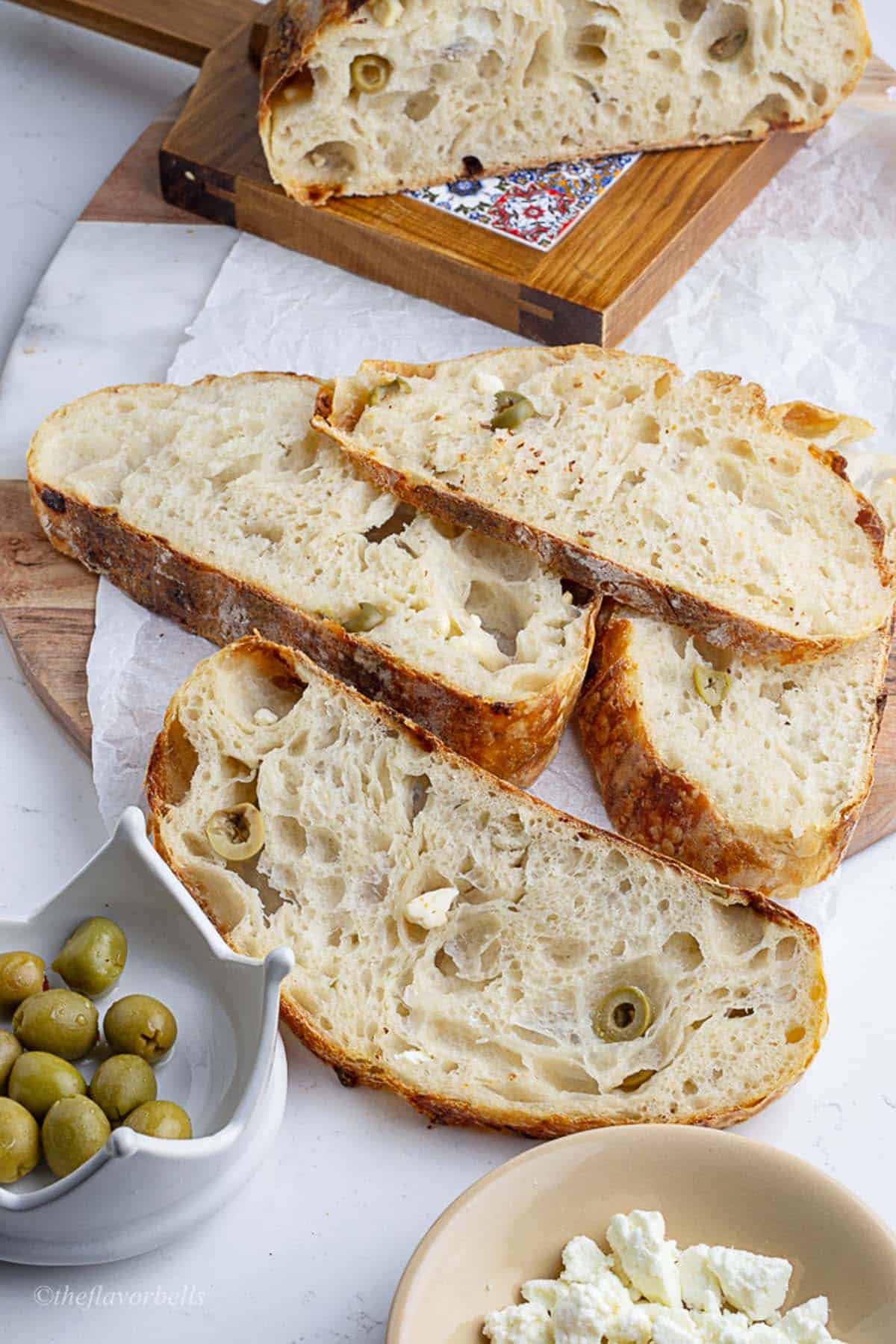 4 slices of sourdough bread showcasing the crumbs and inclusions