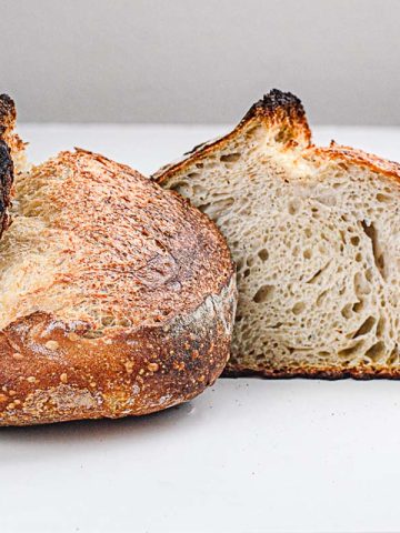 a high temperature baked sourdough loaf sliced into half
