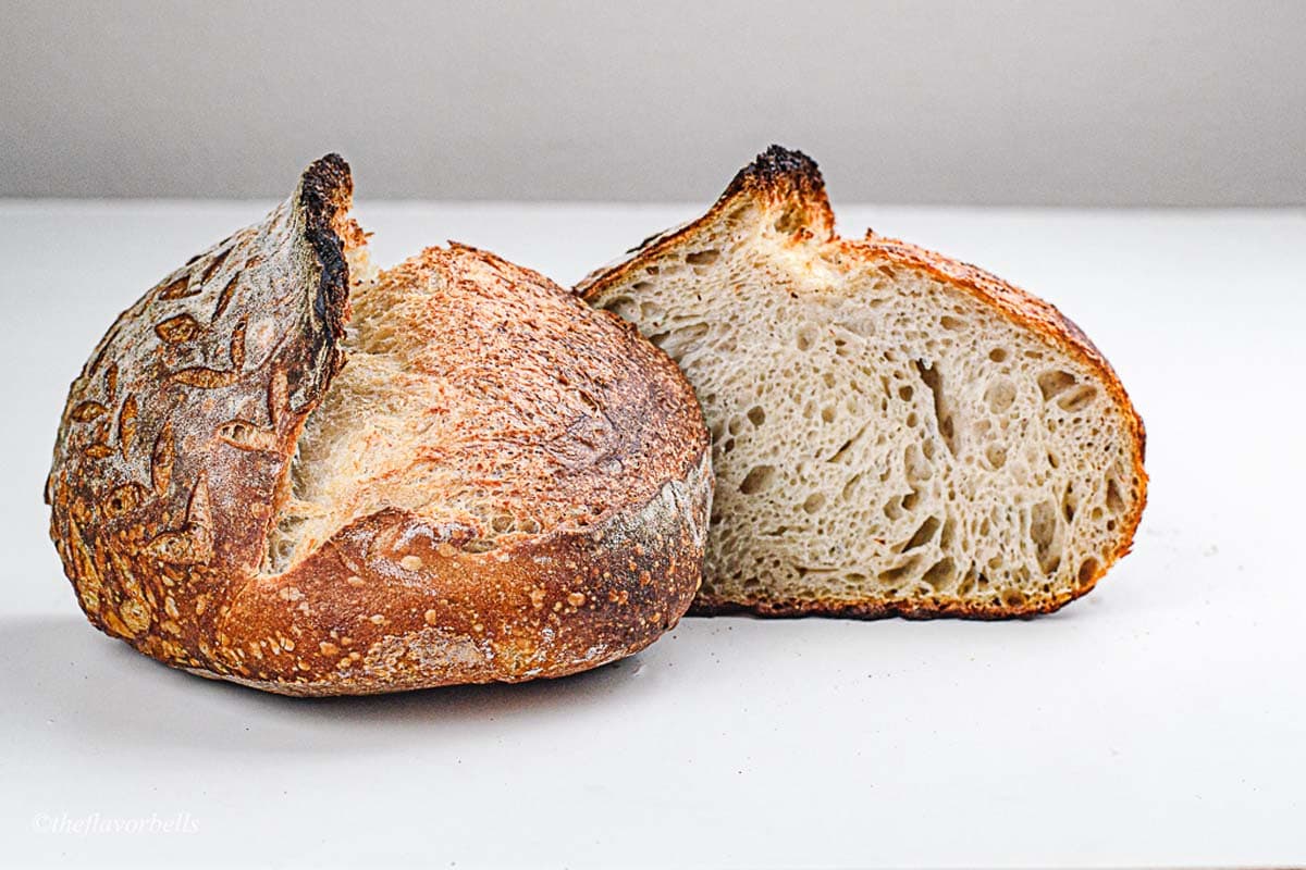 a high temperature baked sourdough loaf sliced into half
