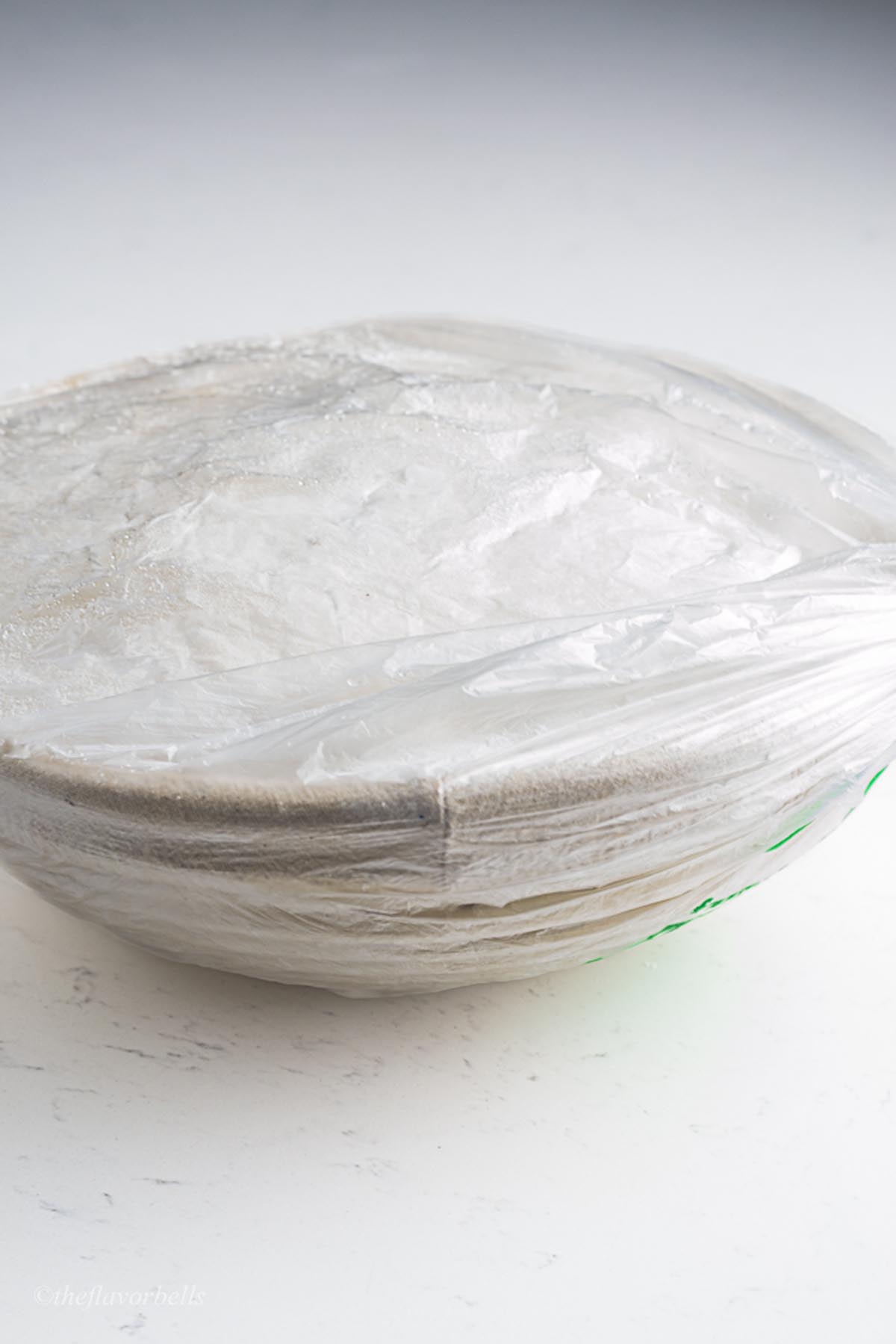 a banneton packed in an air tight polybag with sourdough loaf inside it ready to be frozen.